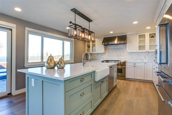 Beautiful updated kitchen with wood floors and gorgeous mint green island.